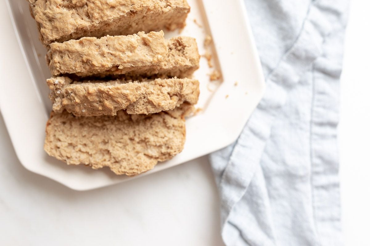 Sliced beer bread on a white platter.