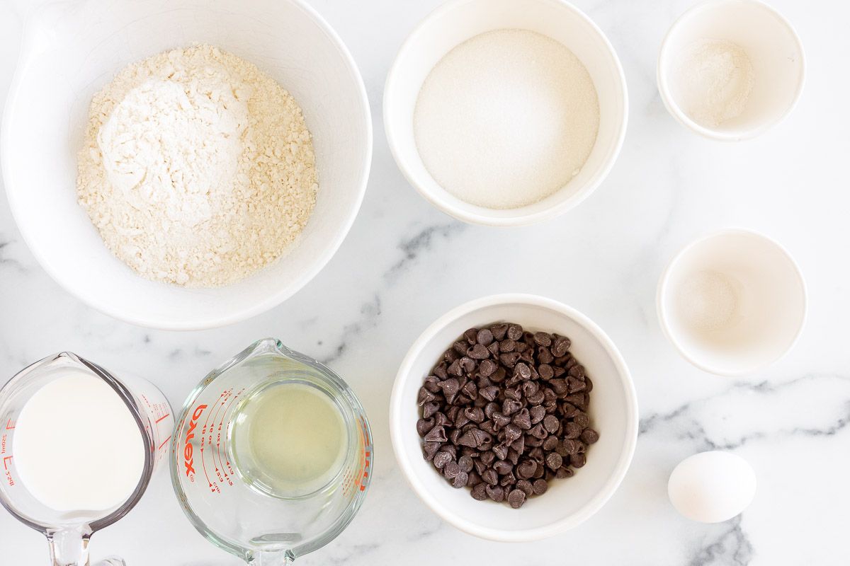 Ingredients for chocolate chip bread laid out on a marble surface