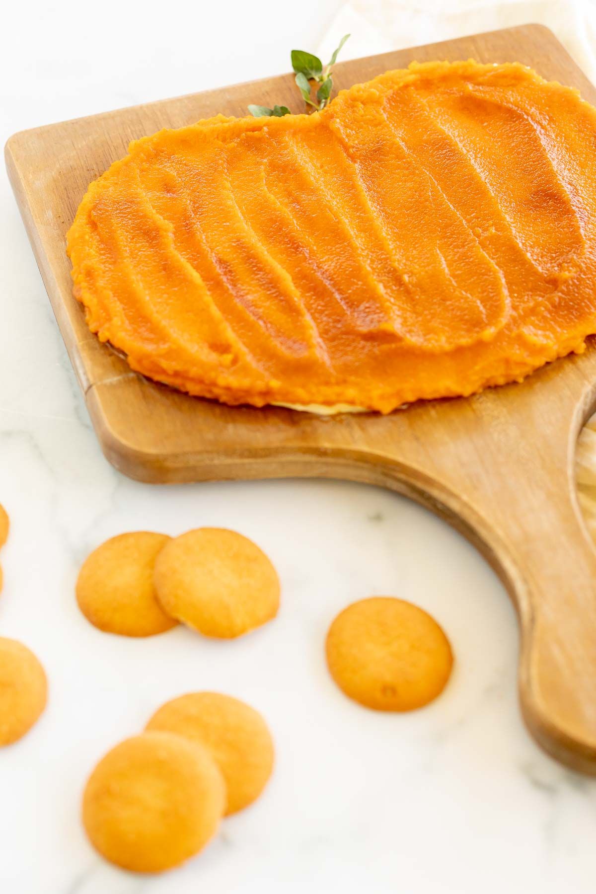 A butter board for fall, topped with pumpkin puree and spices, nilla wafers in the foreground