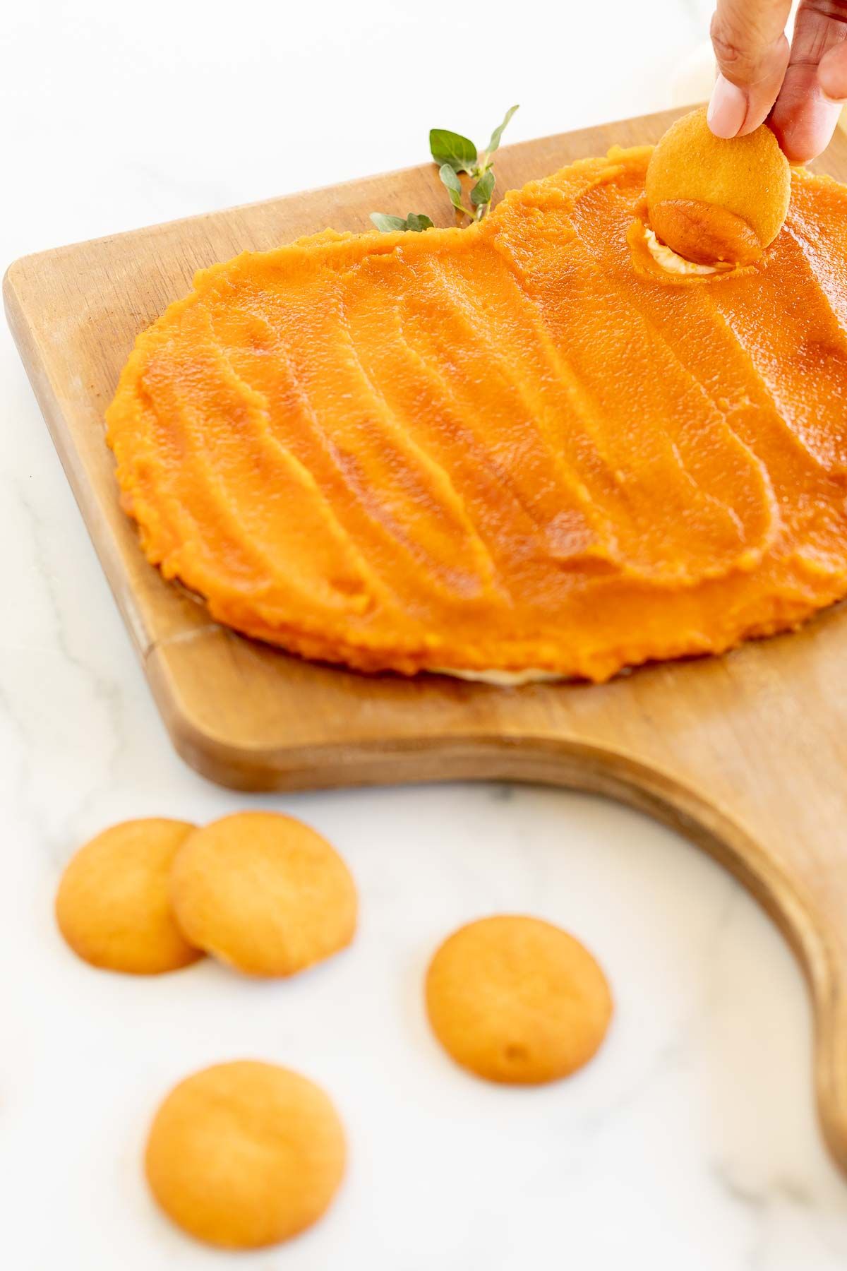 A butter board for fall, topped with pumpkin puree and spices, nilla wafers in the foreground