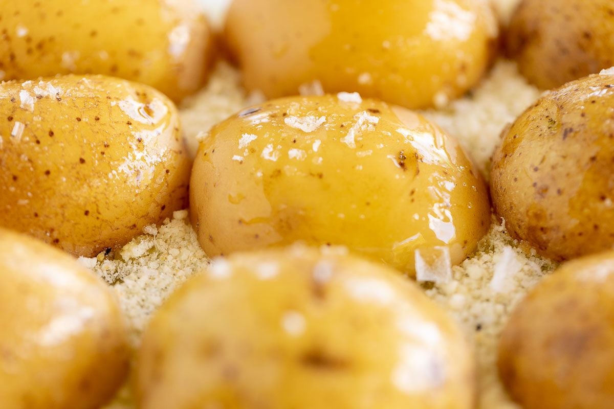 A white baking dish full of parmesan potatoes after baking.