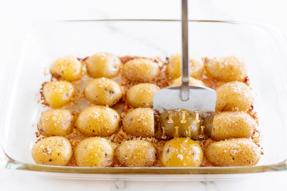 A white baking dish full of parmesan potatoes after baking.