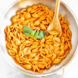 A stainless steel pan full of Gigi Hadid pasta, a wooden spoon to the side.