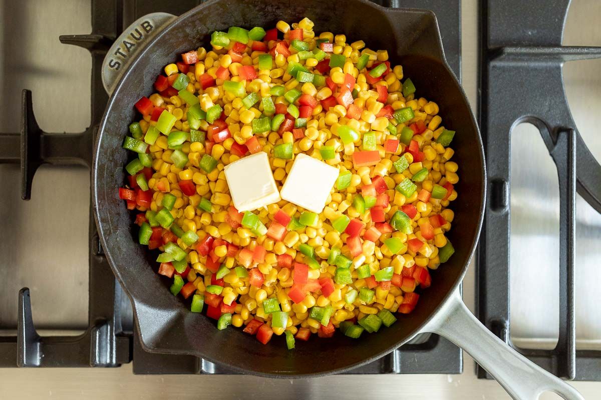 A saute pan filled with homemade mexicorn, with two pats of butter on top.