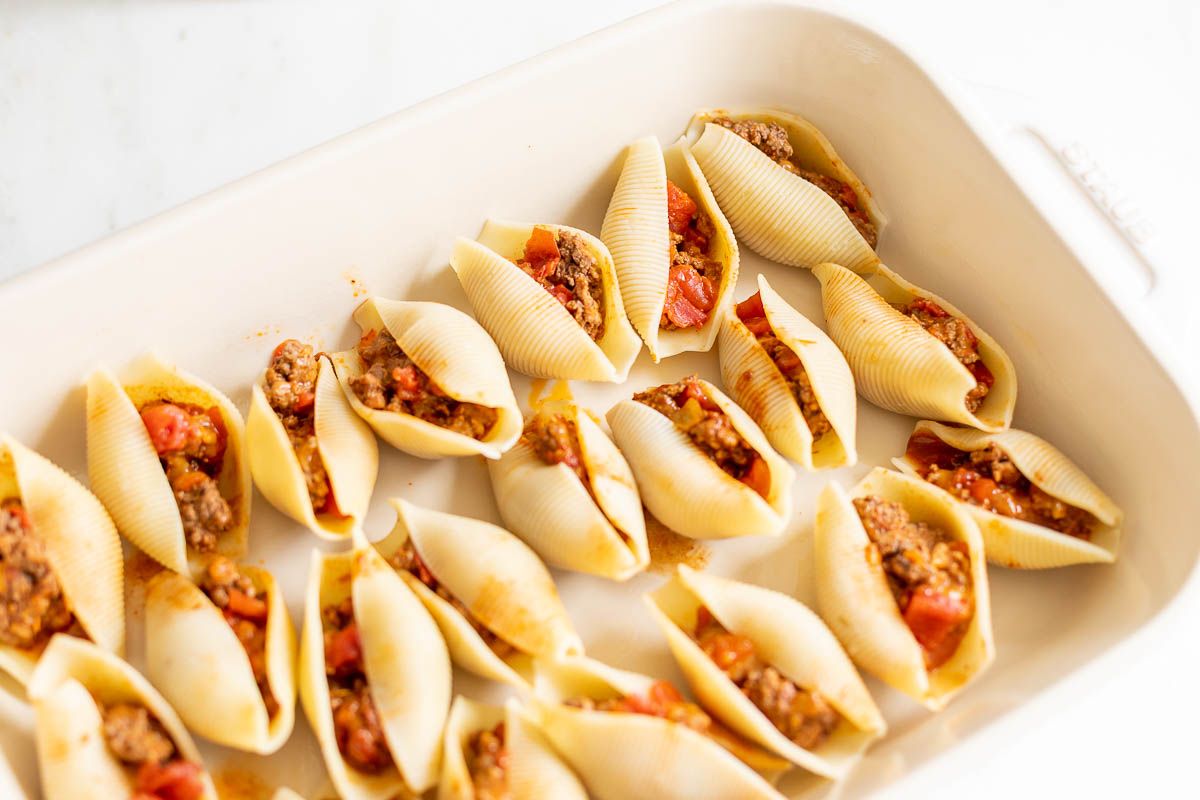 Stuffed shells in a white baking pan.