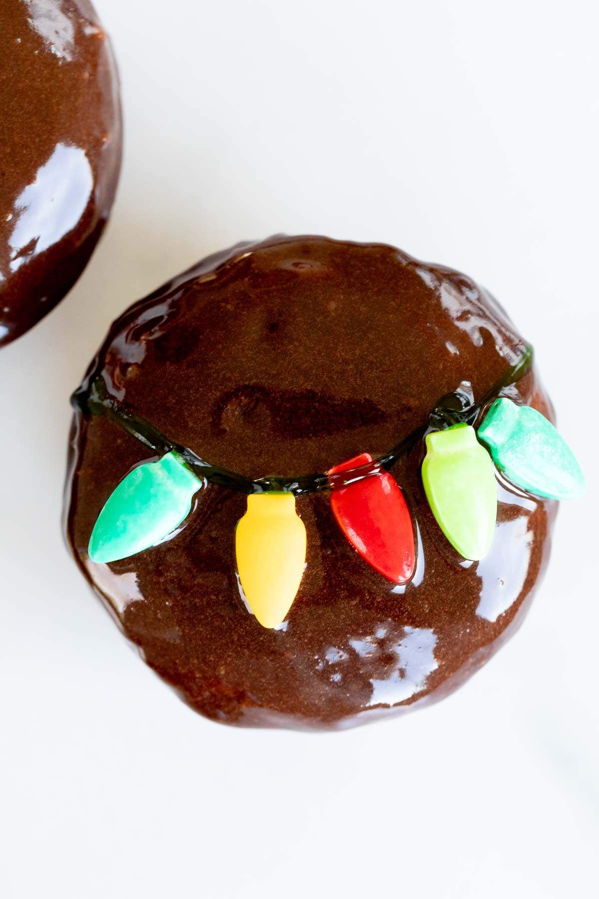 A homemade chocolate Christmas donut on a marble surface.