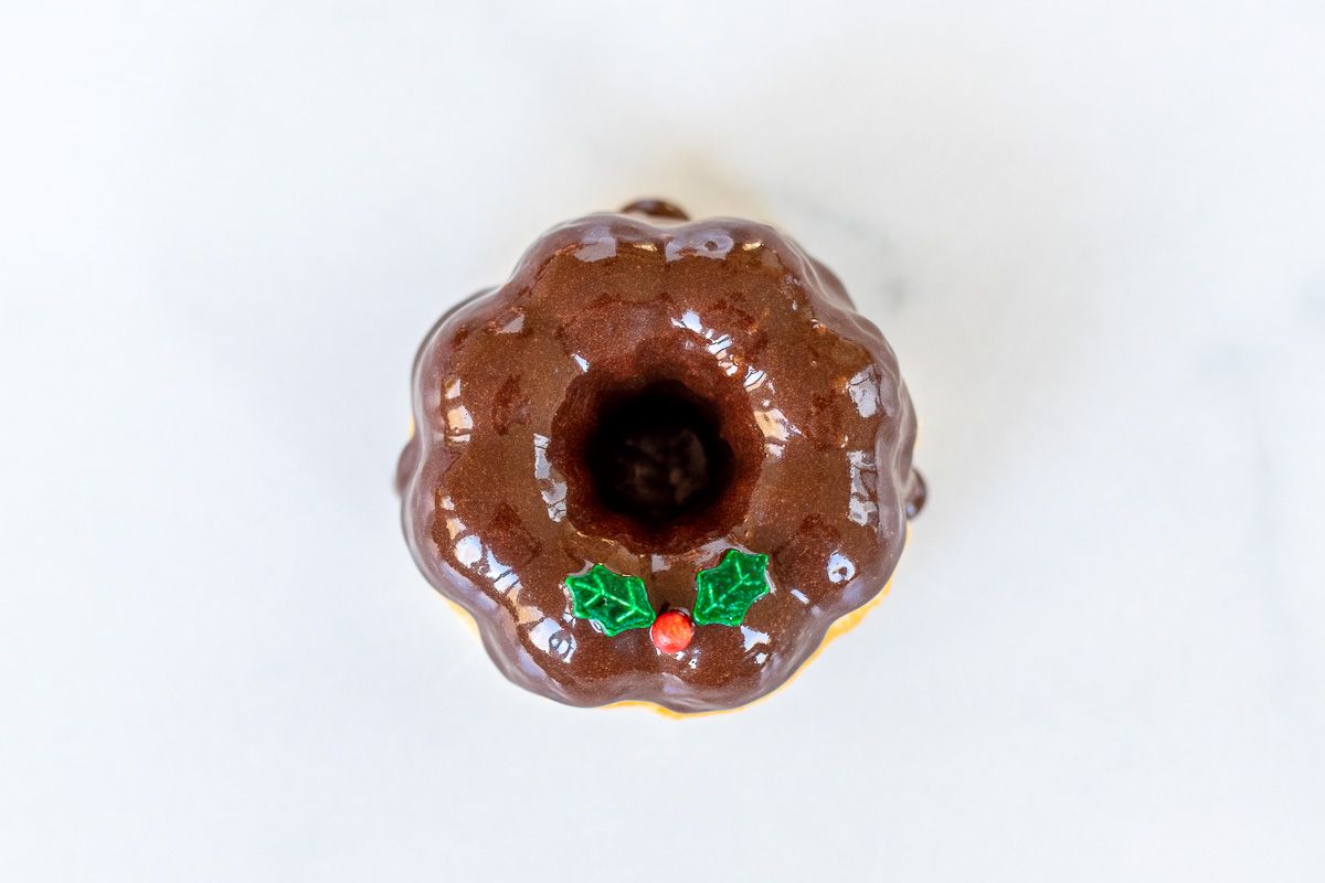 A homemade chocolate Christmas donut on a marble surface.