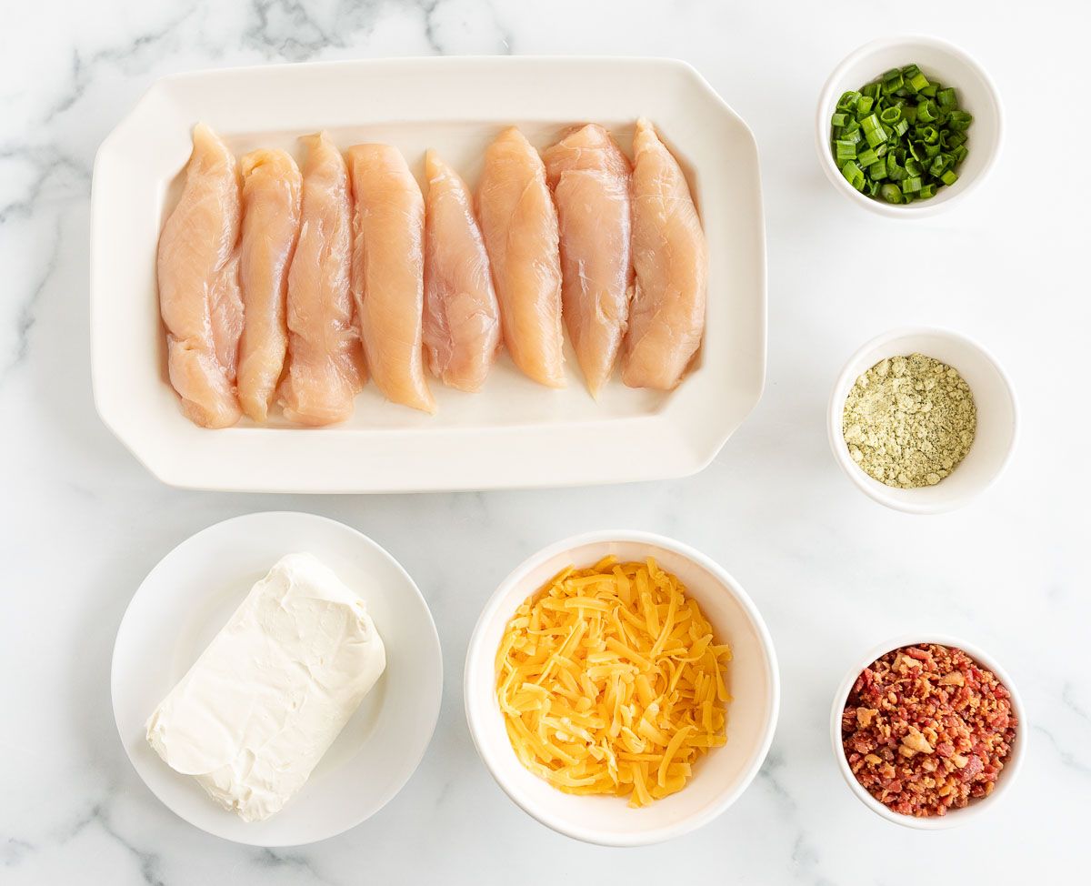 Ingredients for crack chicken laid out on a white marble countertop