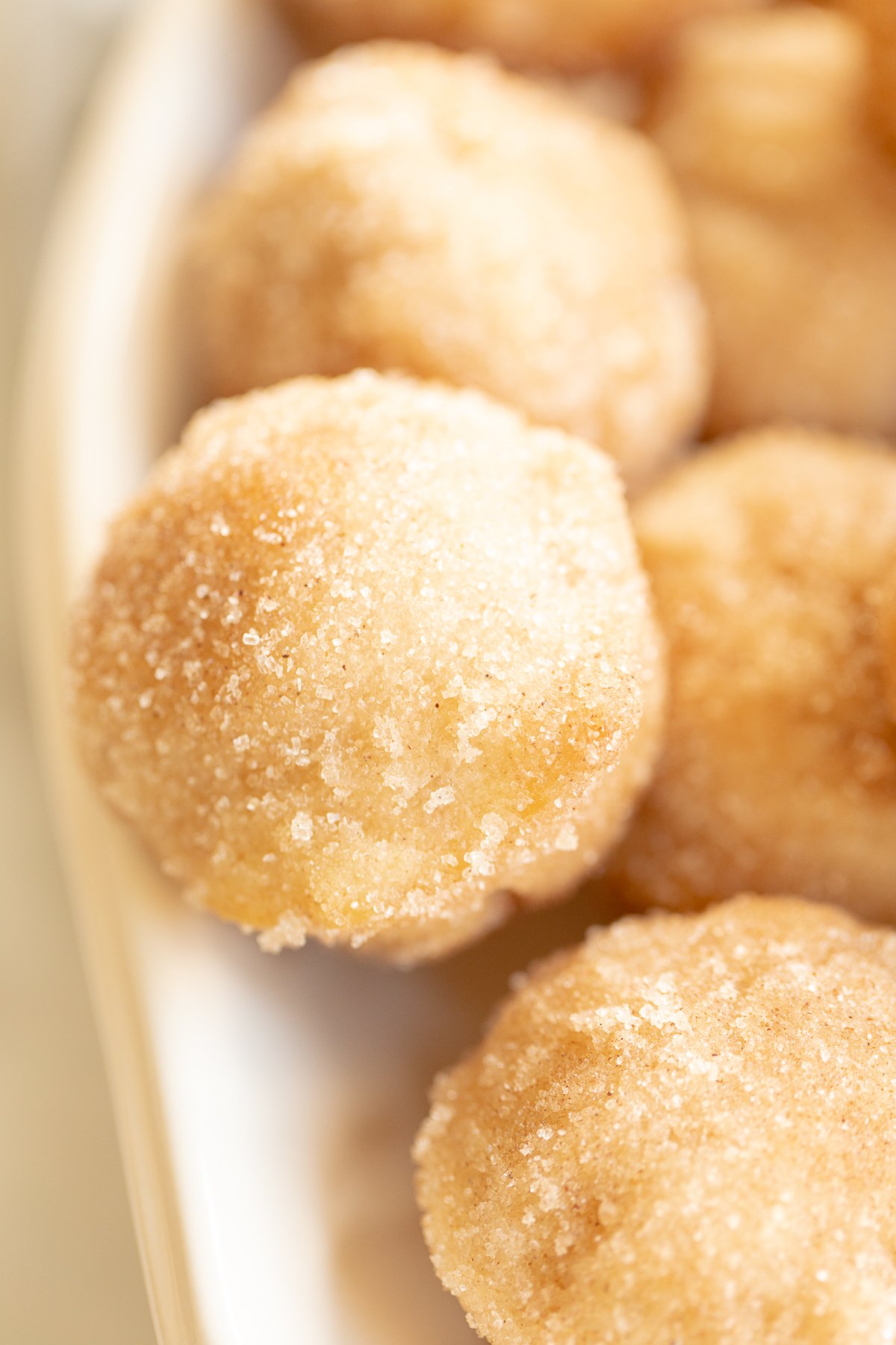 Close up of mini cinnamon muffins, rolled in cinnamon sugar.