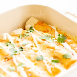 Cheese enchiladas in a white baking dish.