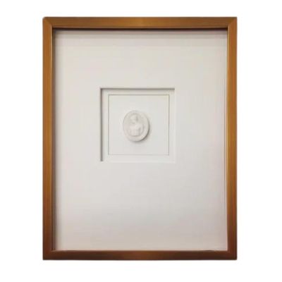 A framed intaglio with a white matting.