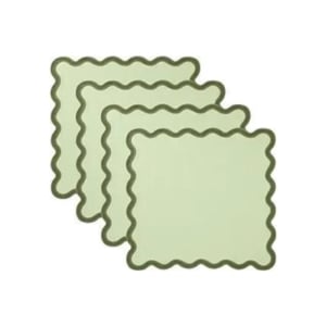 Four green scalloped decor placemats on a white background.