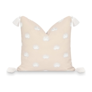 This beige pillow features white flowers and tassels, perfect for adding a touch of elegance to any room.