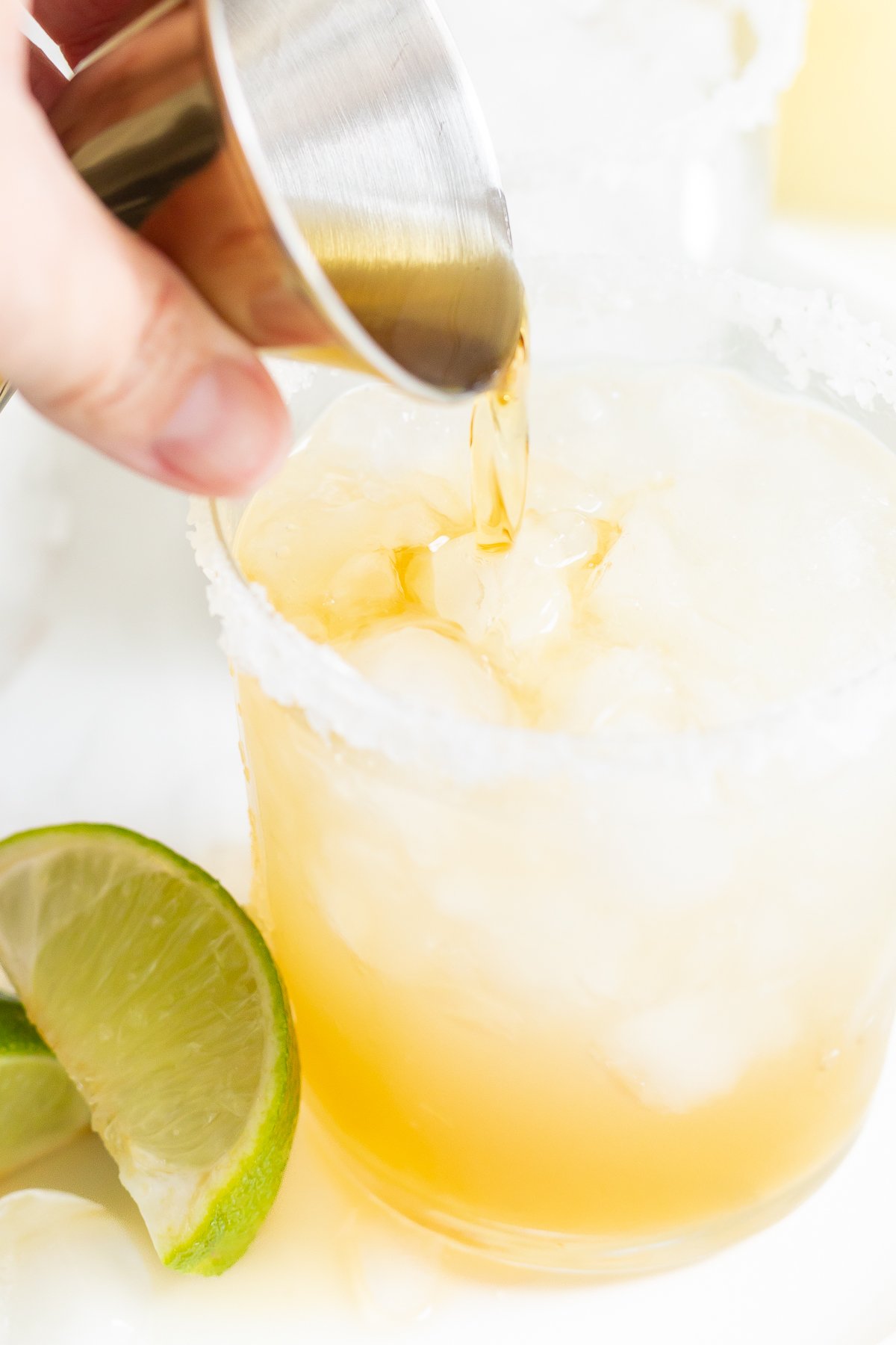 pouring a Grand Marnier float into a Cadillac Margarita