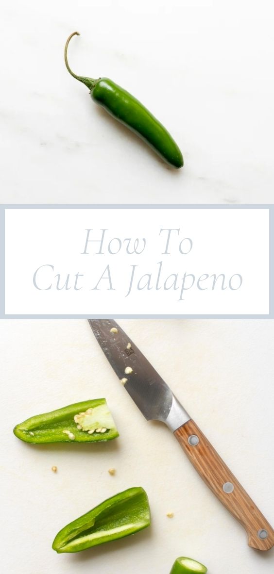 On a marble counter top, there is a jalapeno and a knife cutting a jalapeno.