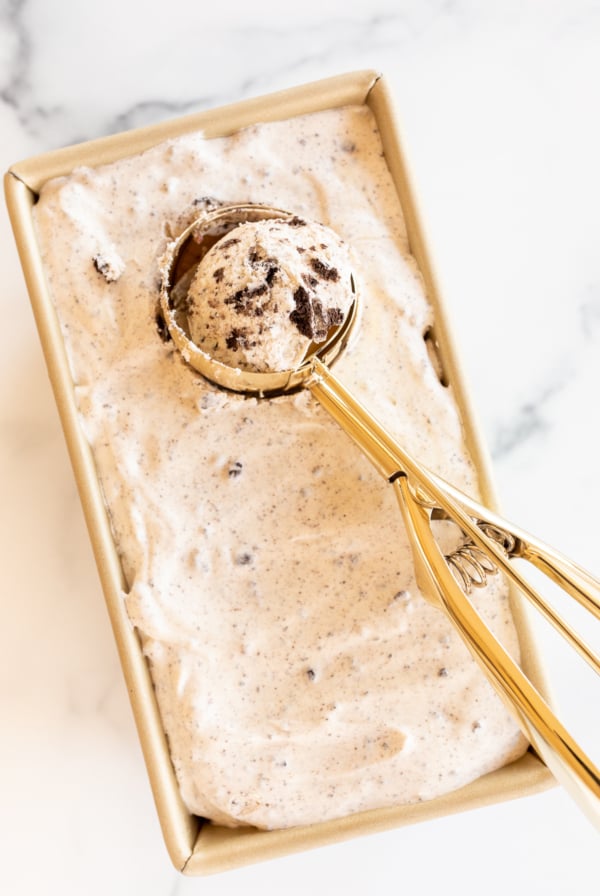 Ice cream scooper in pan of no-churn cookies and cream ice cream