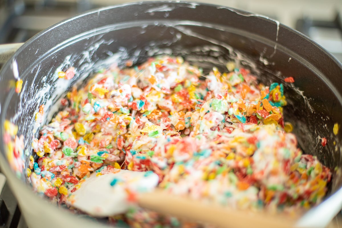 Stirring Fruity Pebbles Treat mixture on stovetop