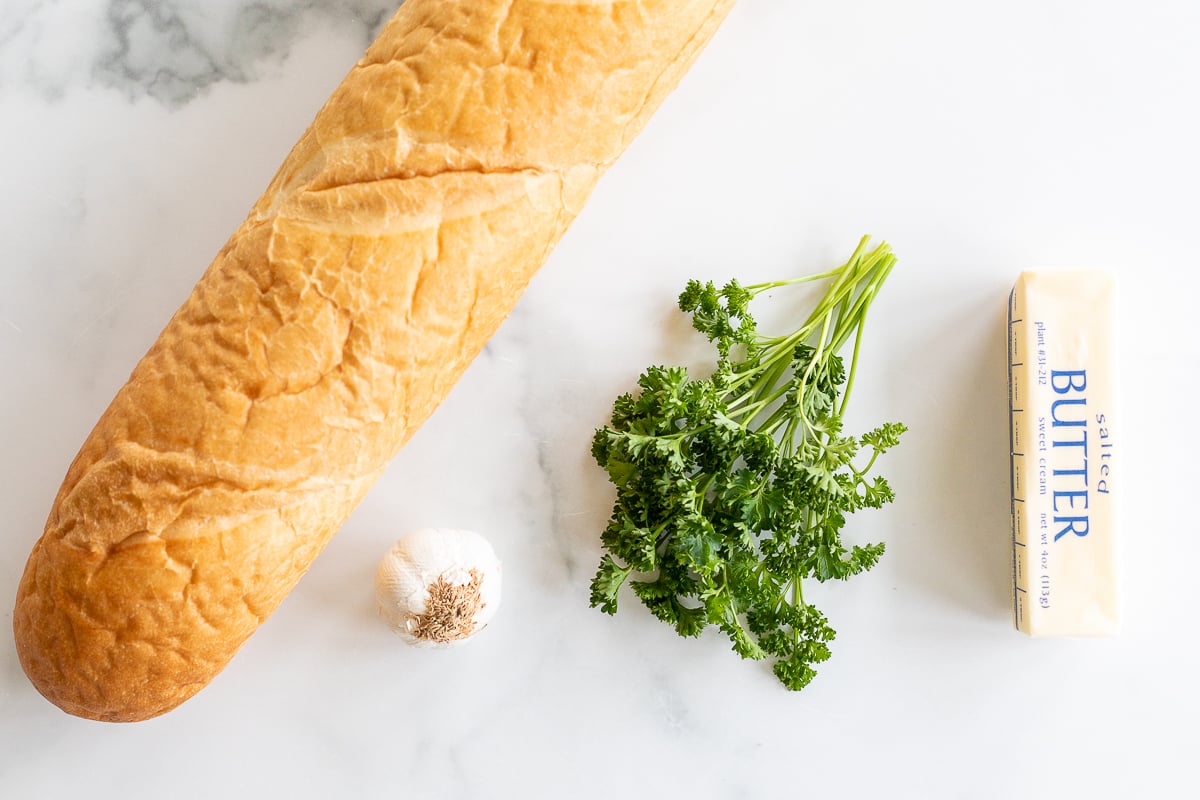 Overhead view of ingredients for homemade garlic bread