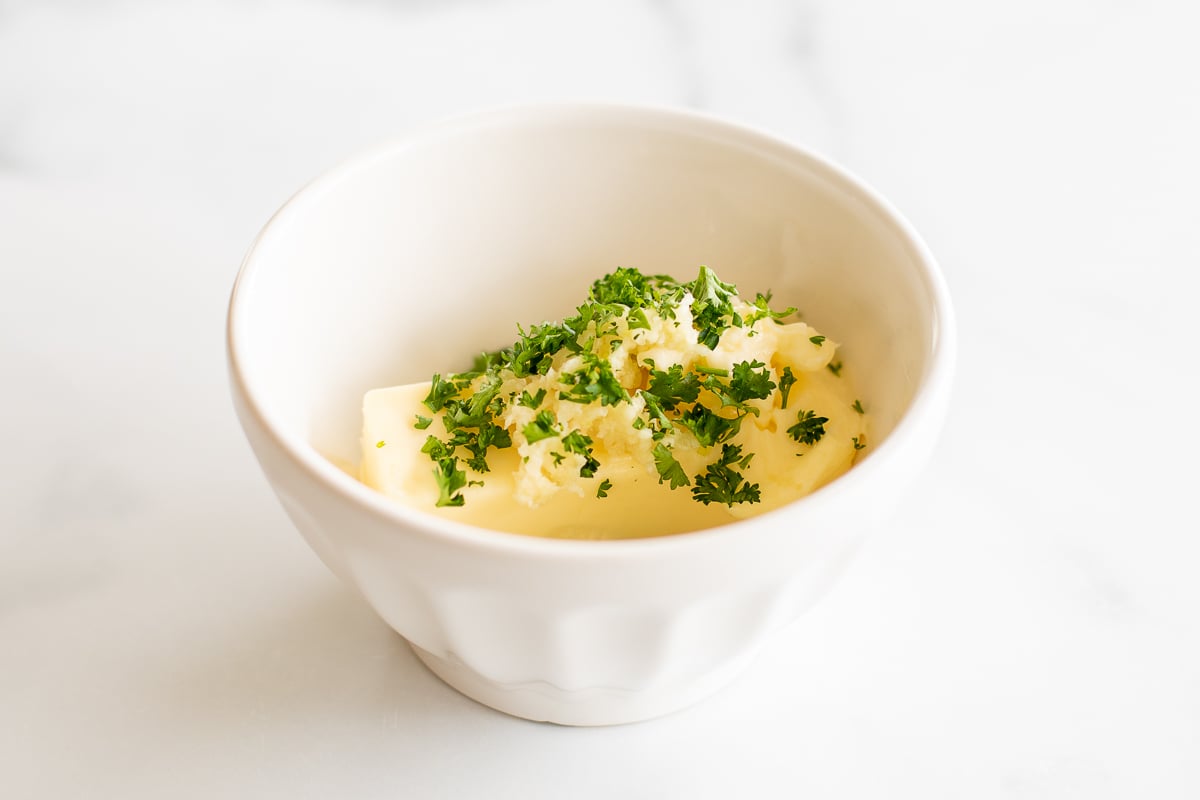 Parsley, garlic, and butter in small bowl before mixing