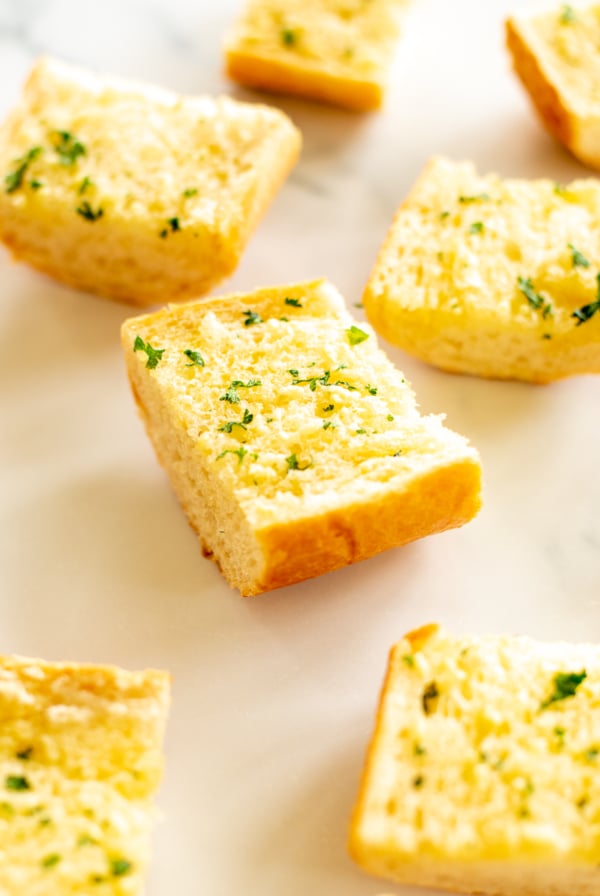 Slices of homemade garlic bread on marble countertop