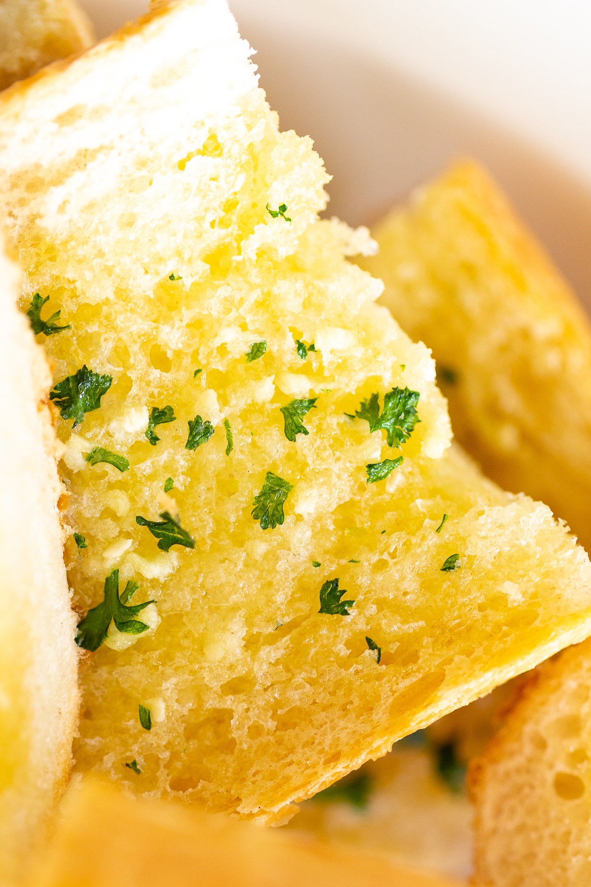 Close up of homemade garlic bread with parsley flakes. 
