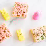 Overhead view of Peeps treats on marble countertop with yellow and pink Peeps
