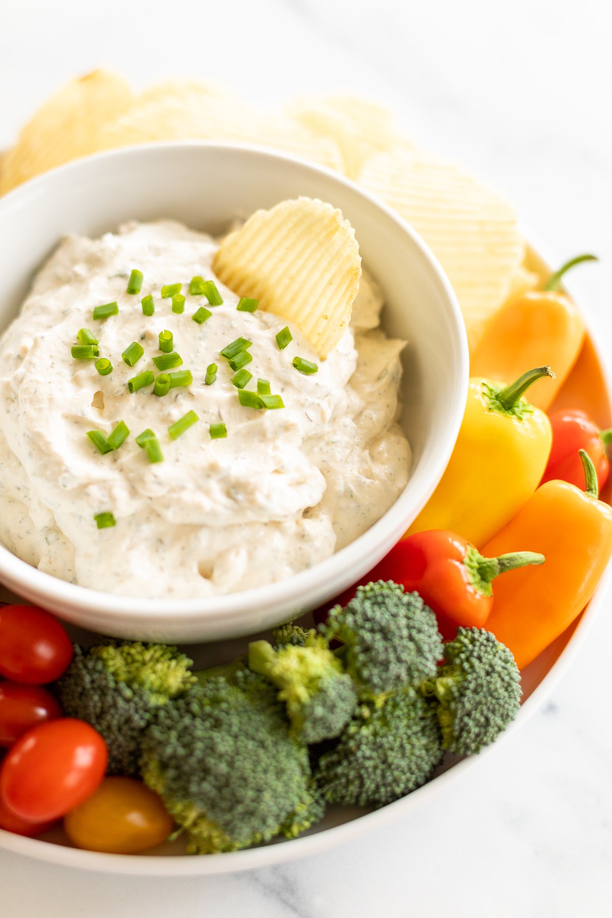 Ridged potato chip in bowl of ranch dip