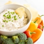 Ridged potato chip in bowl of ranch dip