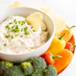 Ridged potato chip in bowl of ranch dip