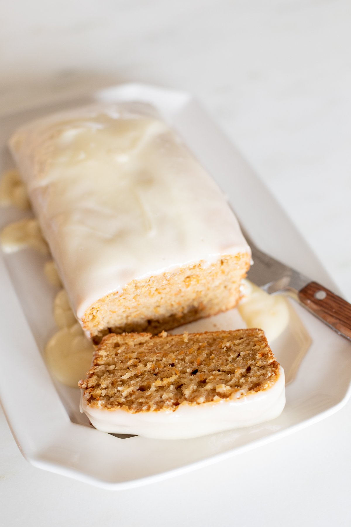 A carrot cake loaf topped with cream cheese glaze