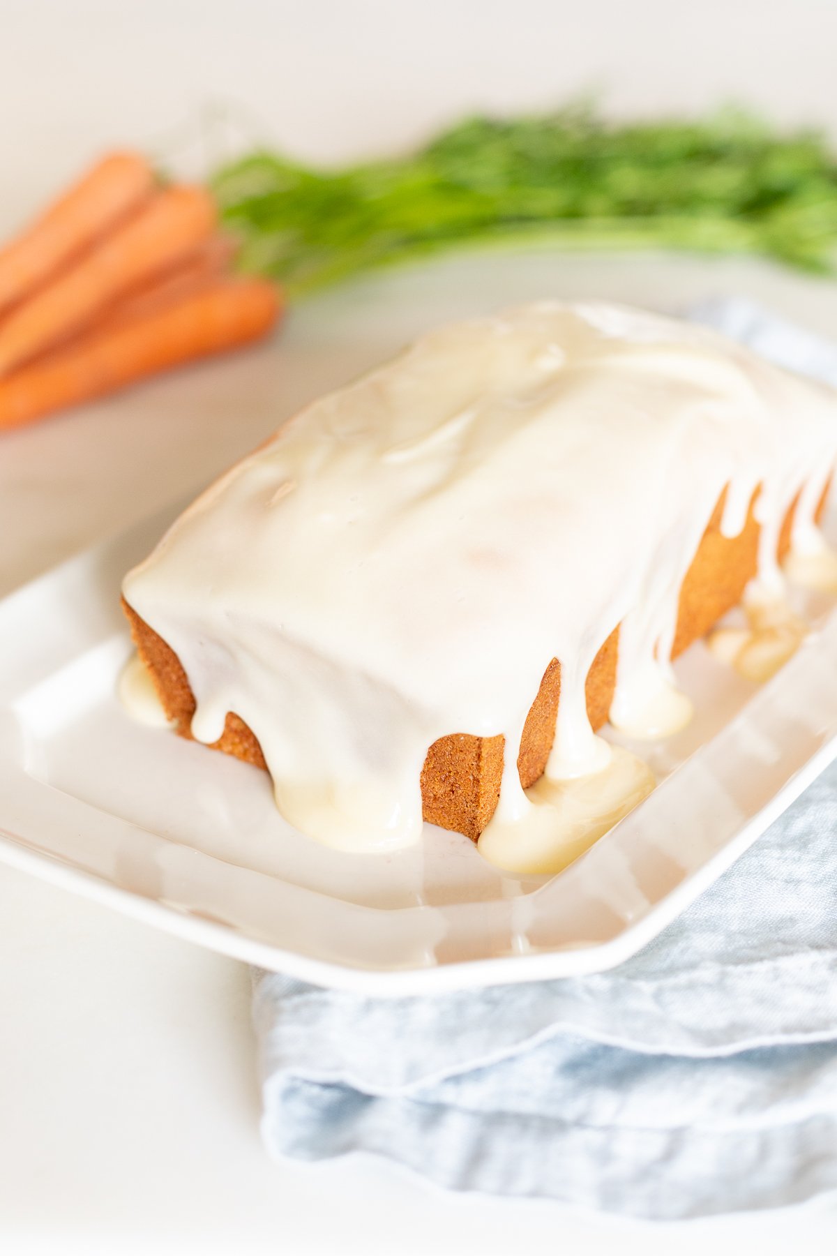 A carrot cake loaf topped with cream cheese glaze