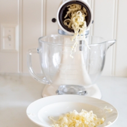 KitchenAid mixer shredding mozzarella cheese with the slicer/shredder attachment