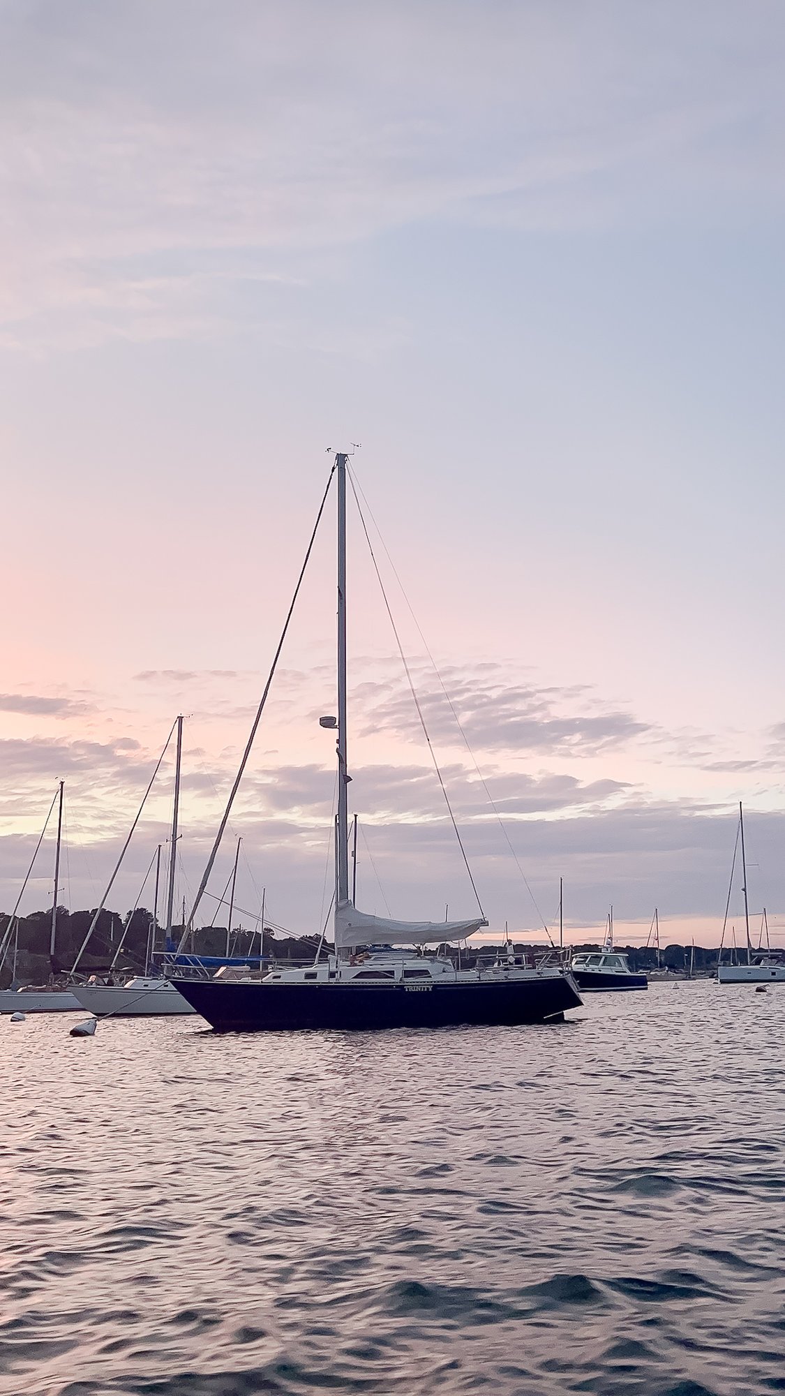 A boat in the water at sunset