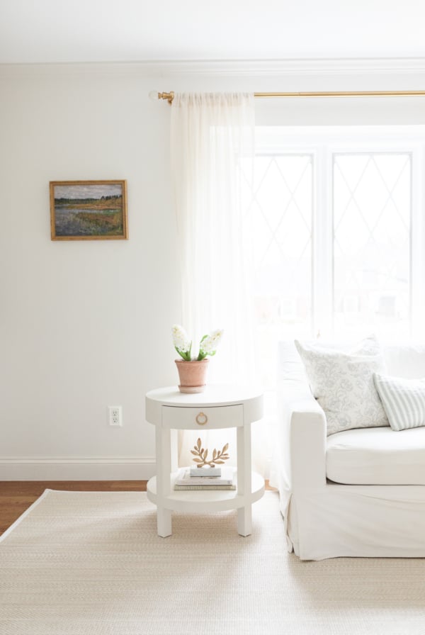 A living room with white walls, white furniture and minimalist decorating