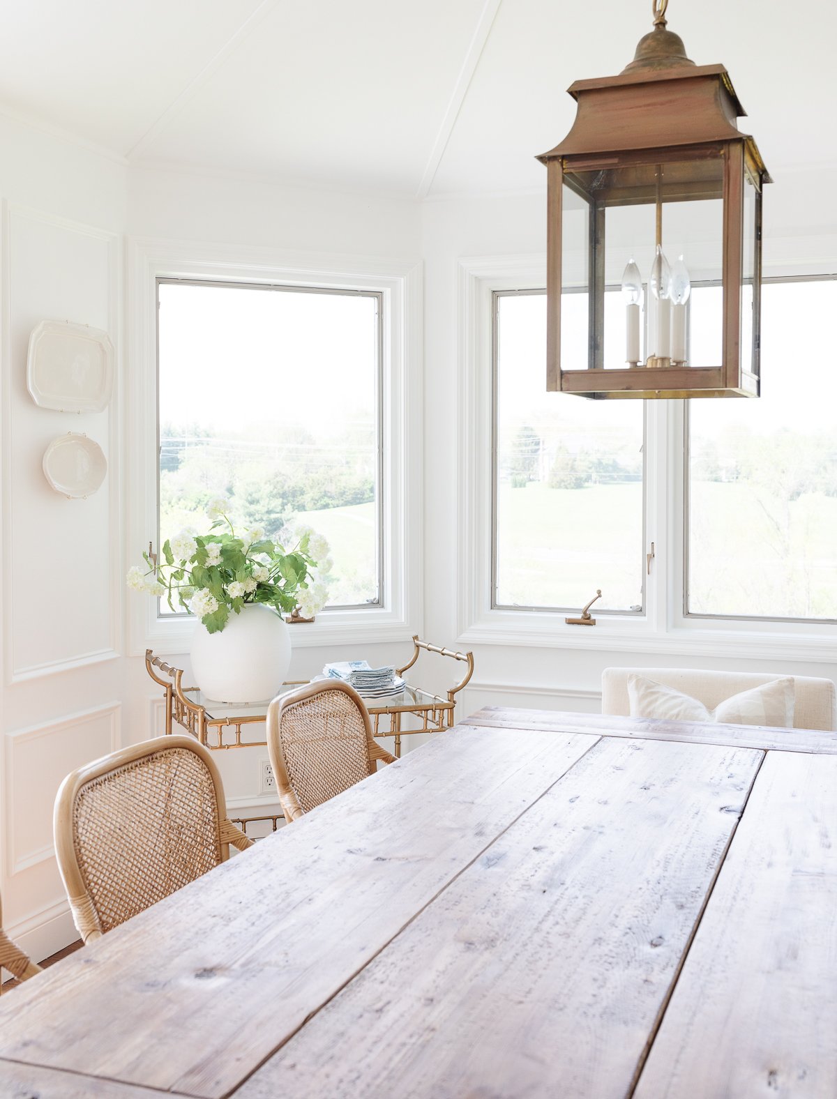 A RH Look for Less wooden table in a dining room.