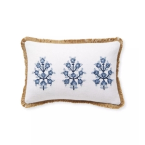 A blue and white pillow with fringes, possibly inspired by Serena and Lily dupes.