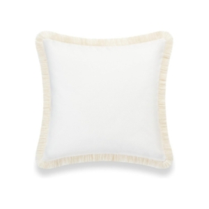 A white pillow with fringe trim, similar to Serena and Lily dupes.