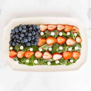 Red white and blue fruit salad designed as American flag on a white platter