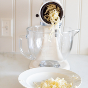 KitchenAid shredder shredding mozzarella into bowl