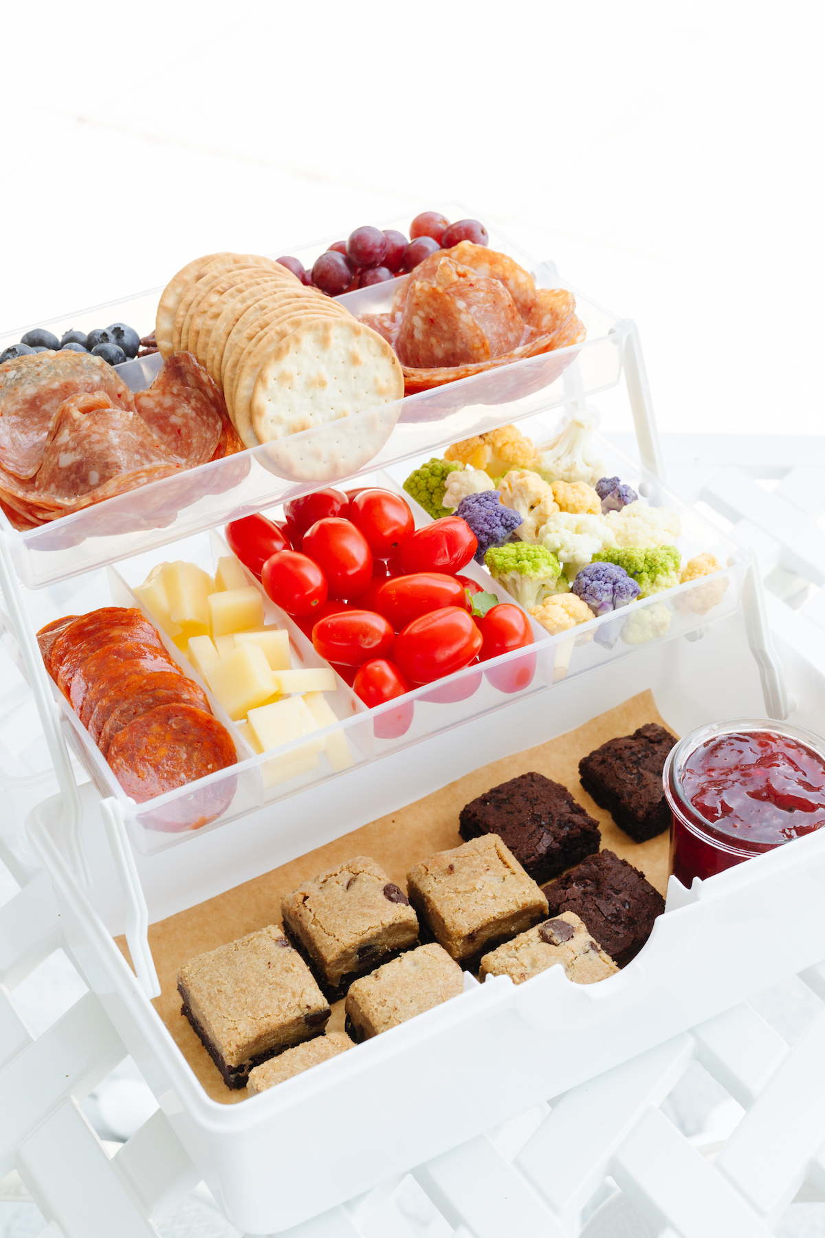 A snackle box on a white table with water in the background.