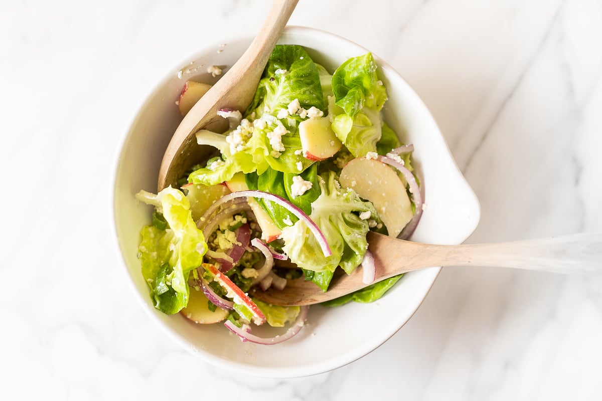 An apple salad in a white bowl