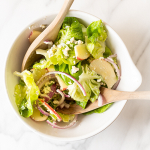 An apple salad in a white bowl