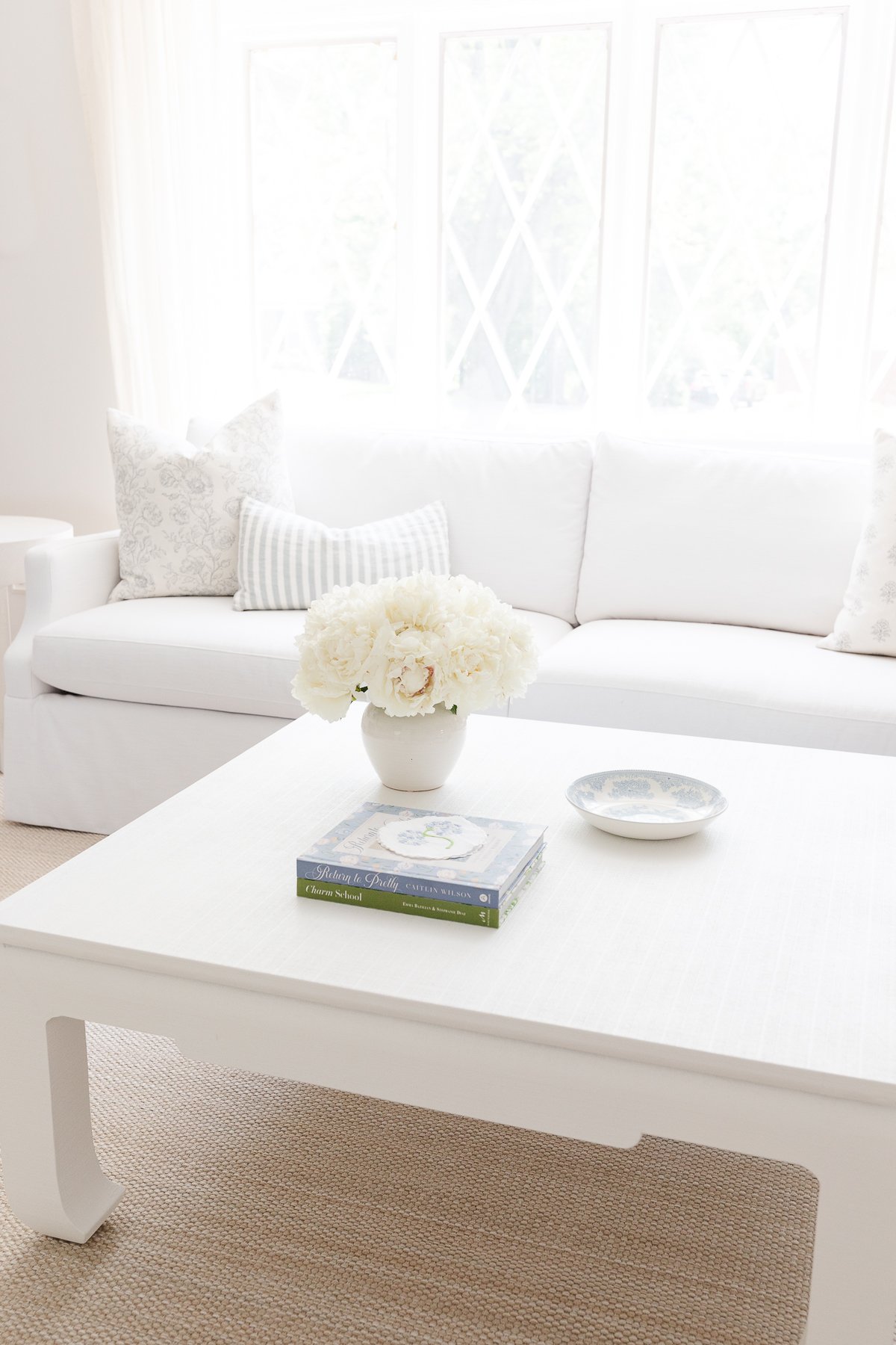 A white Serena and lily sofa in a white living room.