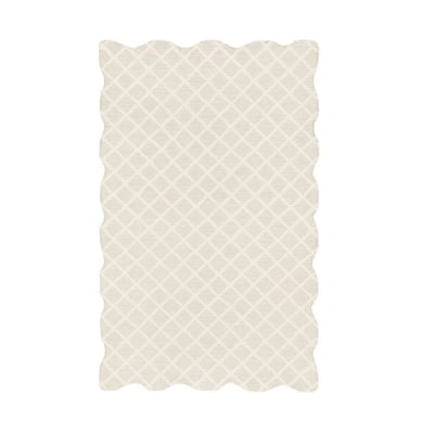 a scalloped rug in cream