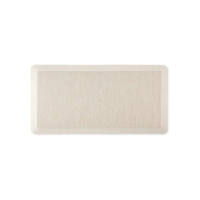 An anti-fatigue beige mat on a white background.