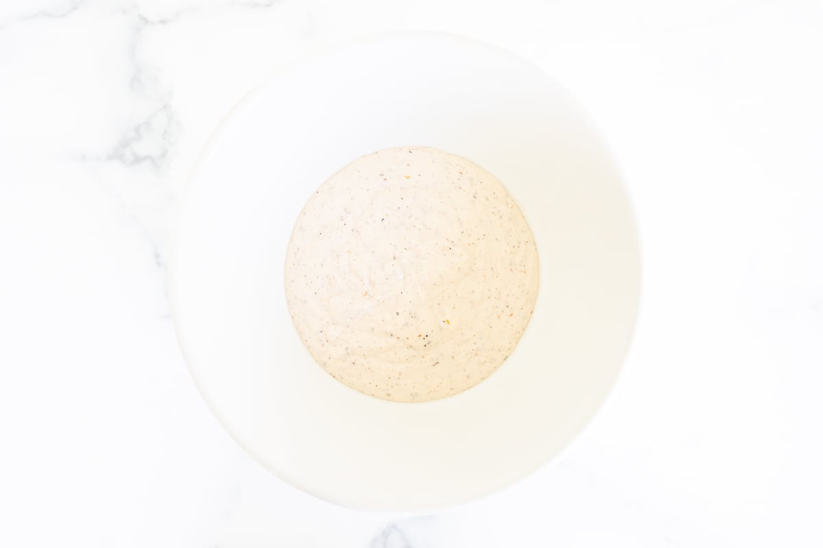 Ingredients for a grinder salad dressing in a white bowl.