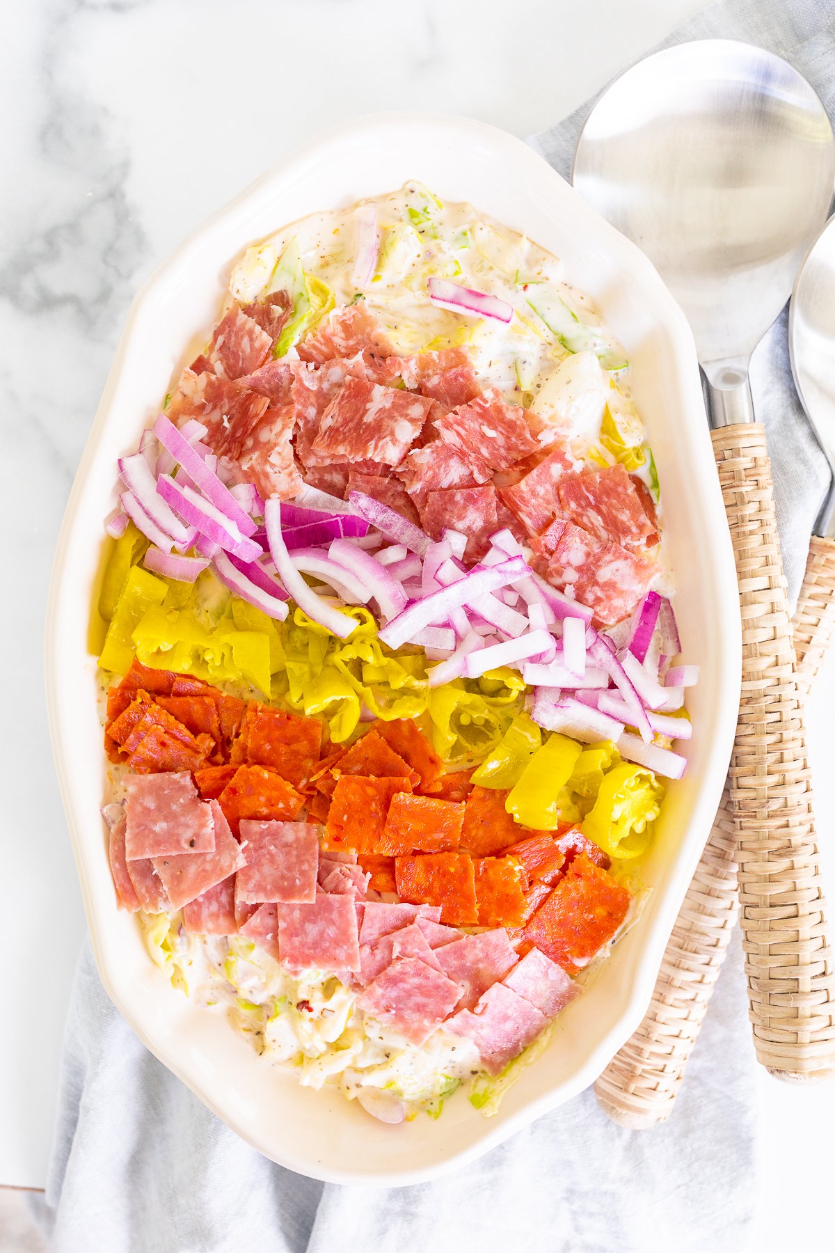 A white oval serving platter filled with an Italian grinder salad recipe.