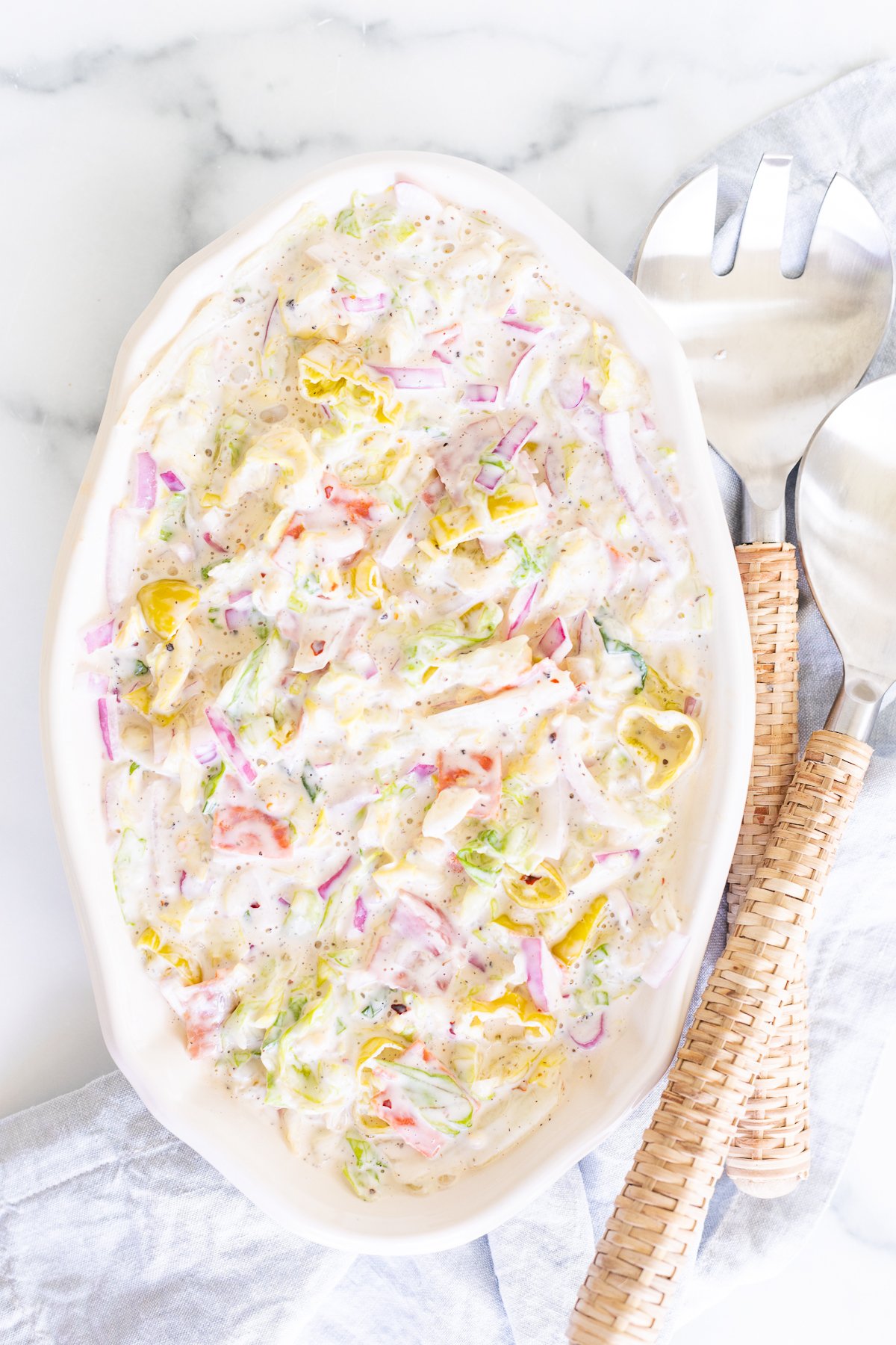 A white oval serving platter filled with an Italian grinder salad recipe.