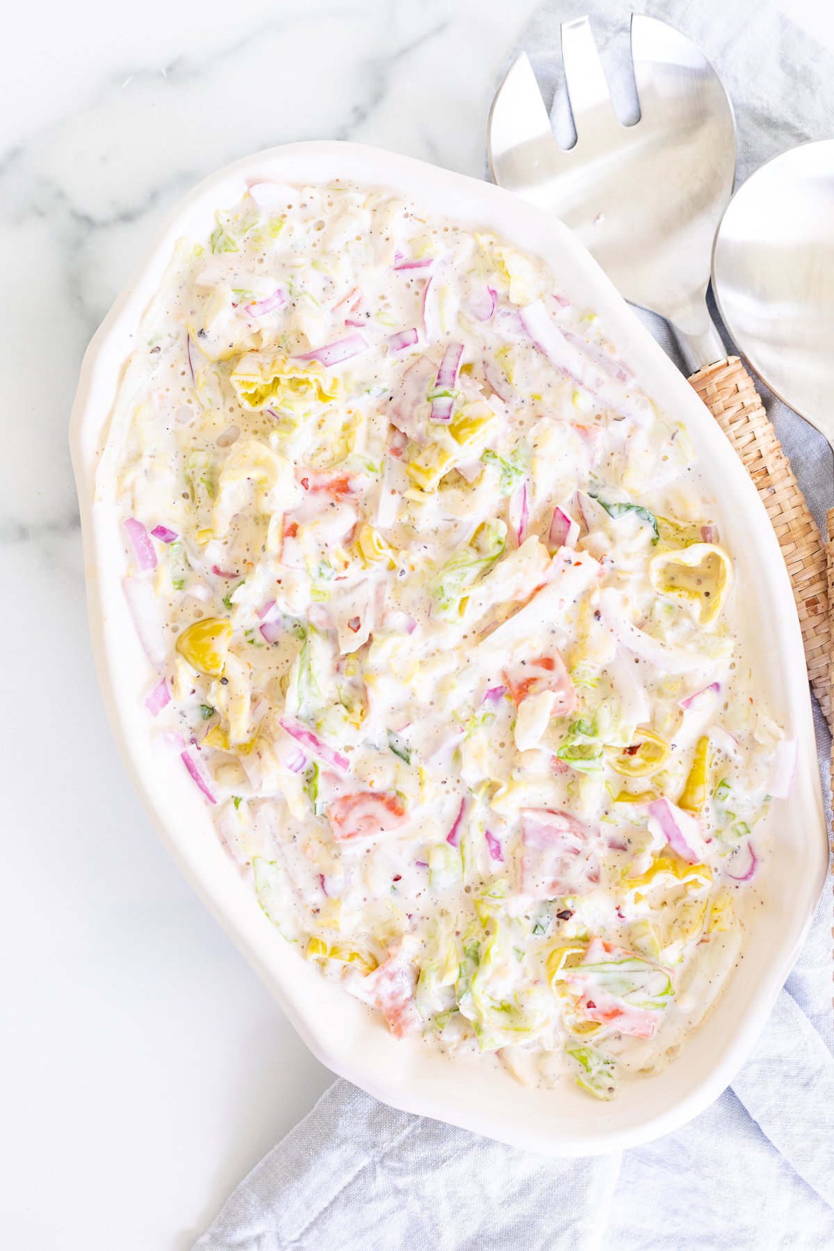 A white oval serving platter filled with an Italian grinder salad recipe. 