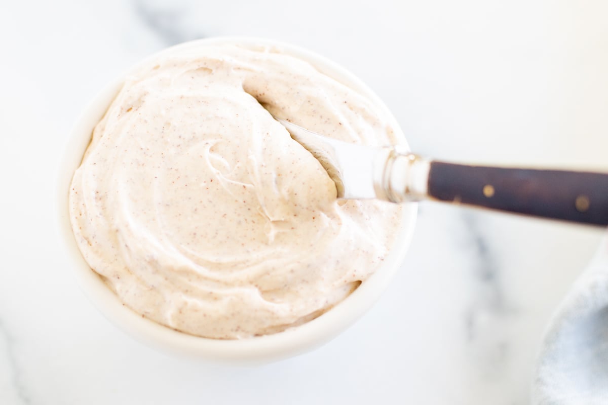 A white bowl of cinnamon cream cheese.